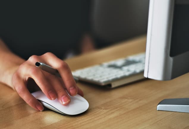  Person using computer mouse to use a computer